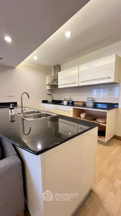 Modern kitchen with sleek black countertops and open layout design