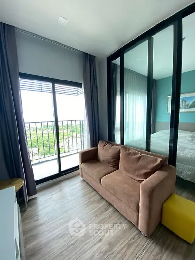 Modern living room with glass partition and balcony view in stylish apartment