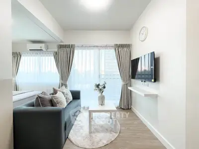 Modern living room with sleek design, featuring a cozy sofa, wall-mounted TV, and large windows with elegant curtains.