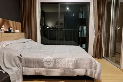Cozy bedroom with modern decor and large window for natural light.