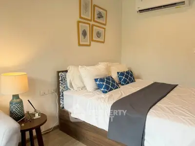 Cozy bedroom with stylish decor and air conditioning, perfect for relaxation.