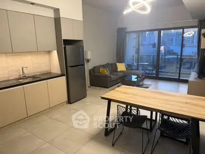Modern open-plan kitchen and living room with city view balcony.