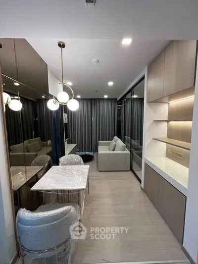 Modern living room with elegant dining area and stylish lighting in a contemporary apartment.