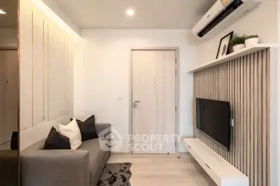 Modern living room with sleek design, featuring a cozy sofa, wall-mounted TV, and stylish decor.