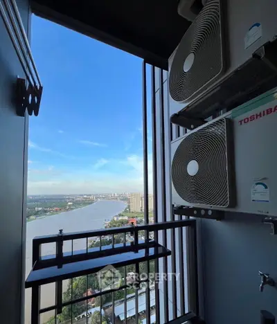 Stunning river view from high-rise balcony with air conditioning units.