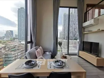Modern living room with city view, featuring stylish decor and large windows in a high-rise apartment.
