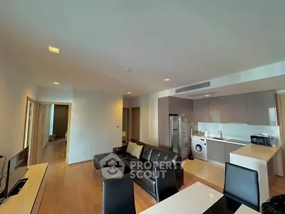 Modern open-layout living room with sleek kitchen and stylish furniture in a contemporary apartment.