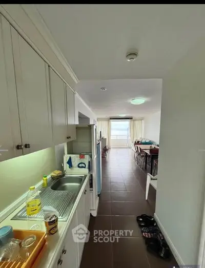 Spacious kitchen with open layout leading to dining area and balcony with stunning view.