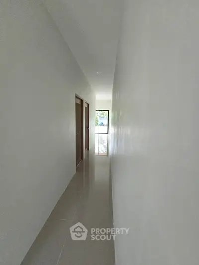 Sleek modern hallway with glossy floors and natural light