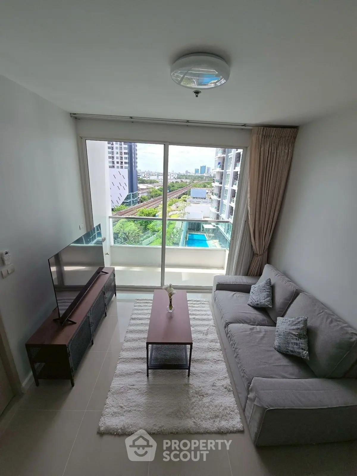 Modern living room with balcony view in high-rise apartment