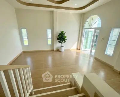 Spacious living room with modern design and large windows for natural light