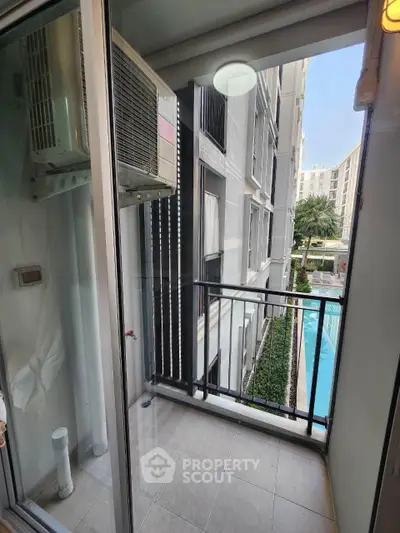 Charming balcony with pool view in modern apartment complex