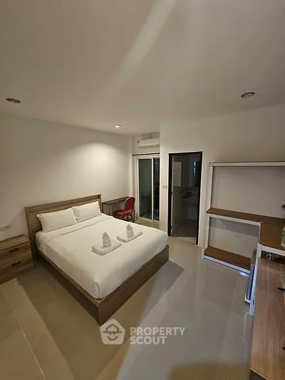 Spacious modern bedroom with minimalist design and natural light