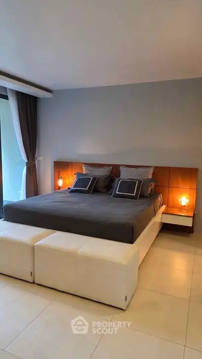 Luxurious bedroom with modern decor and ambient lighting, featuring a king-size bed and elegant furnishings.
