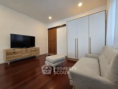 Modern living room with sleek furniture and wooden flooring