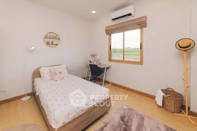 Charming bedroom with cozy decor and scenic window view, perfect for a peaceful retreat.