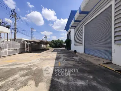 Spacious industrial property with large loading area and secure gated entrance.