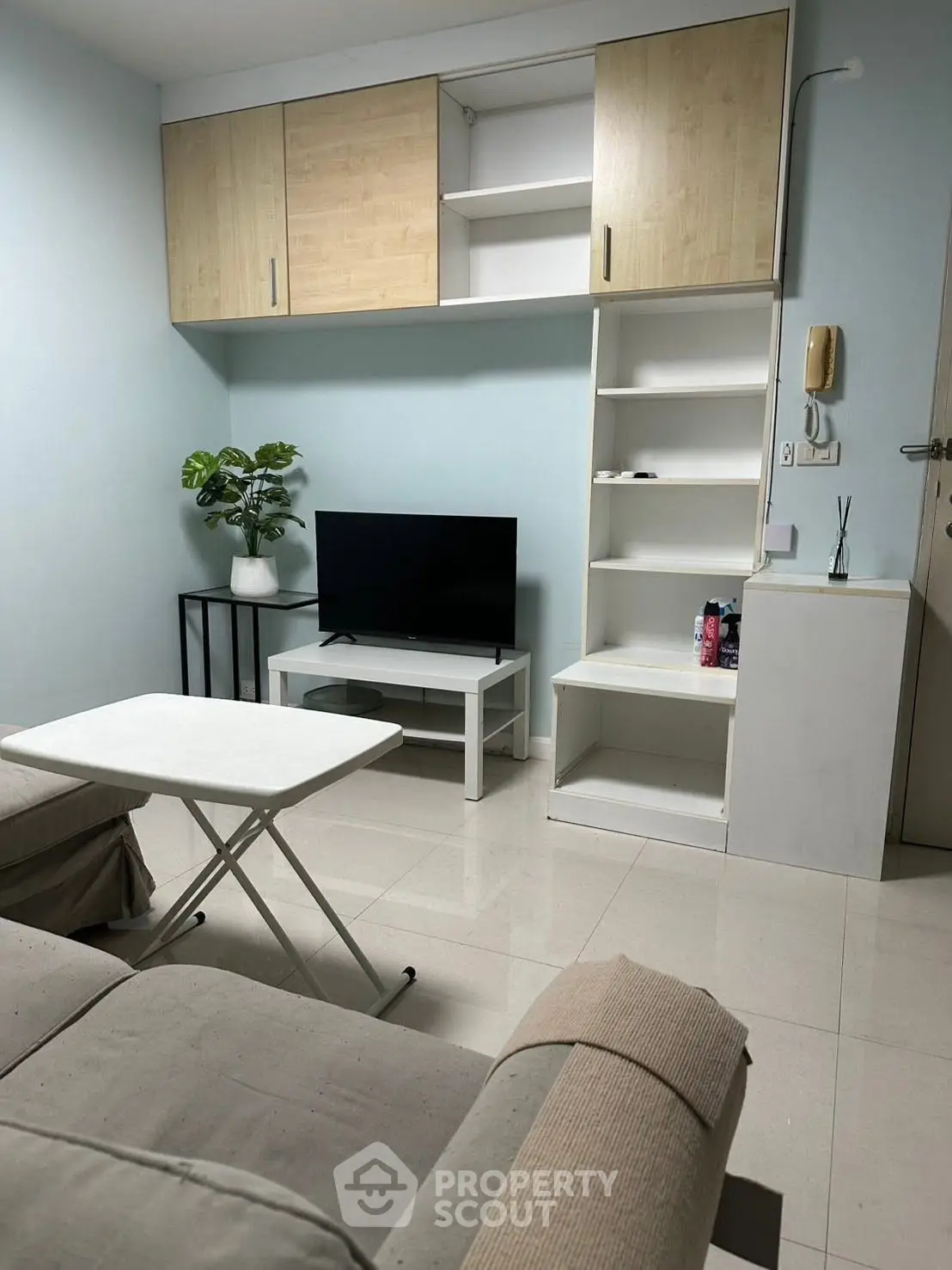 Cozy living room with modern furniture and built-in storage, perfect for urban living.