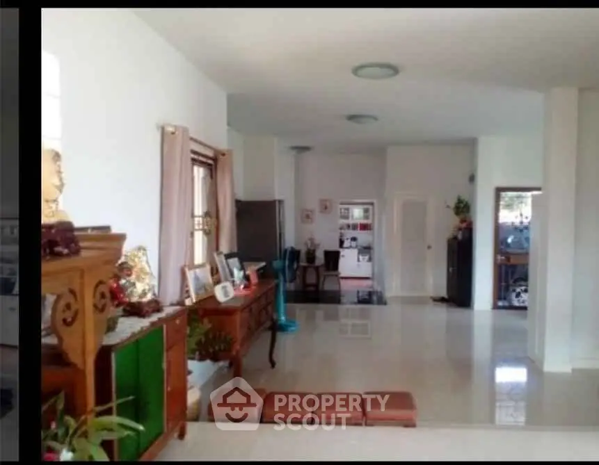 Spacious open-plan living area with elegant decor and ample natural light, perfect for family gatherings.