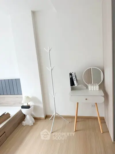 Modern minimalist bedroom with stylish furniture and wooden flooring