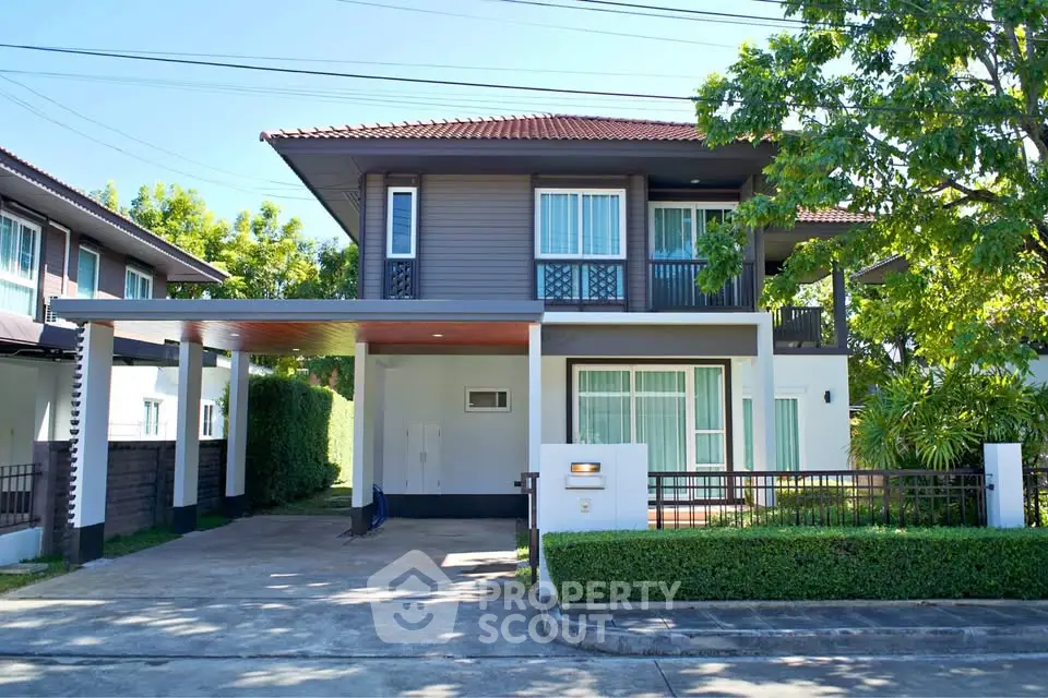 Charming two-story house with modern design, lush greenery, and spacious driveway in a serene neighborhood.