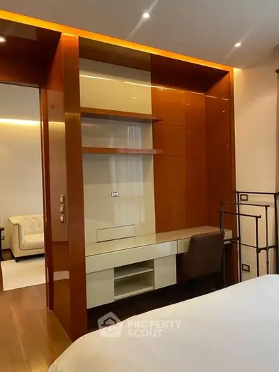 Luxurious bedroom with built-in study area and modern lighting