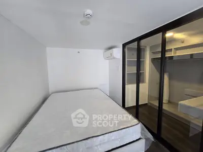 Modern bedroom with sliding glass closet doors and air conditioning unit