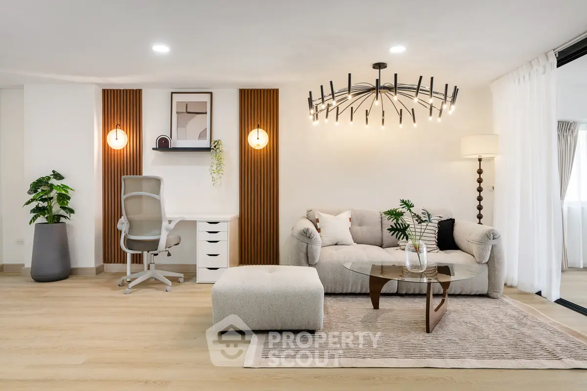 Modern living room with stylish decor, featuring a cozy sofa, elegant lighting, and a chic workspace.