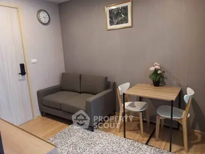 Cozy living room with modern decor, featuring a compact sofa and dining set, ideal for urban living.