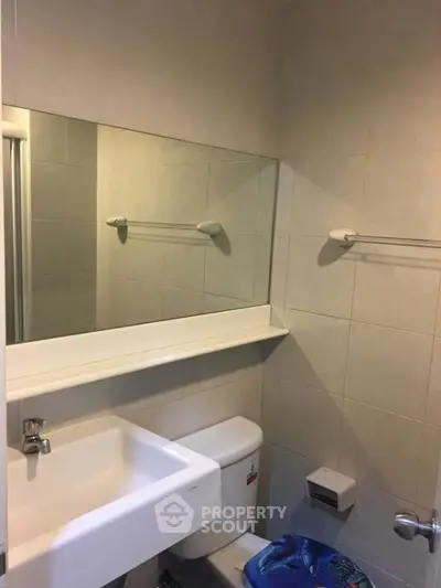 Compact bathroom with modern fixtures and neutral tiles