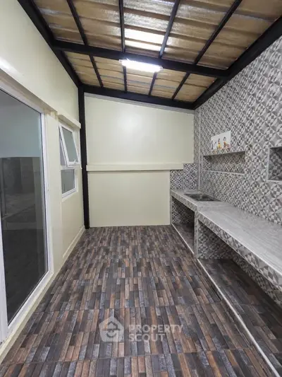 Modern kitchen with stylish tile flooring and sleek countertops in a contemporary home.