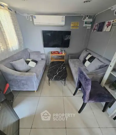 Cozy living room with modern gray sofas and stylish decor