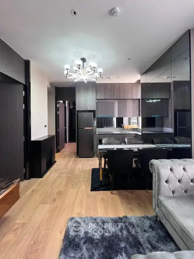 Modern living room with elegant dining area and stylish lighting in a contemporary apartment.