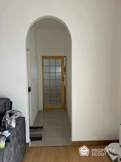 Cozy interior with arched doorway and wooden framed glass door