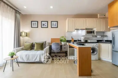 Modern open-plan living room with kitchen, featuring cozy sofa and stylish decor.