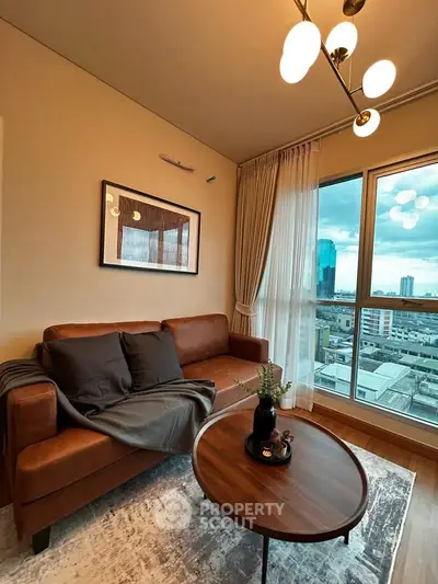 Stylish living room with leather sofa and city view, perfect for urban living.