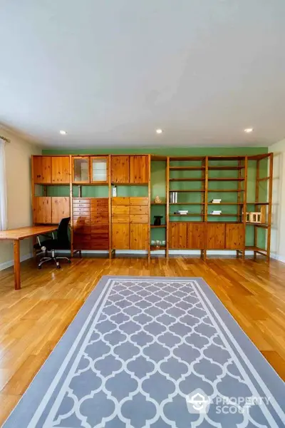 Spacious study room with wooden shelves and elegant flooring