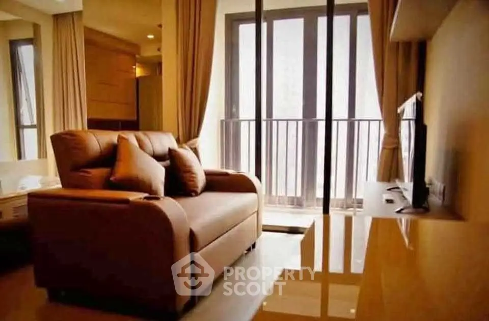 Cozy living room with plush sofa and large windows offering natural light