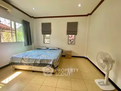 Spacious bedroom with natural light and simple decor
