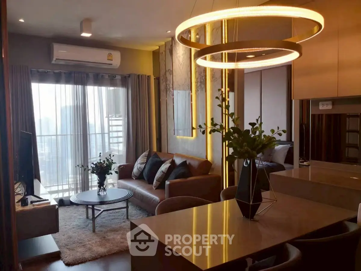 Modern living room with stylish decor and large windows offering city views