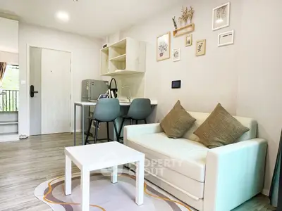 Modern living room with stylish decor and compact kitchen area, perfect for urban living.