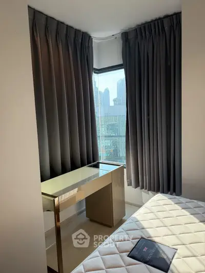 Modern bedroom with city view and sleek desk by the window