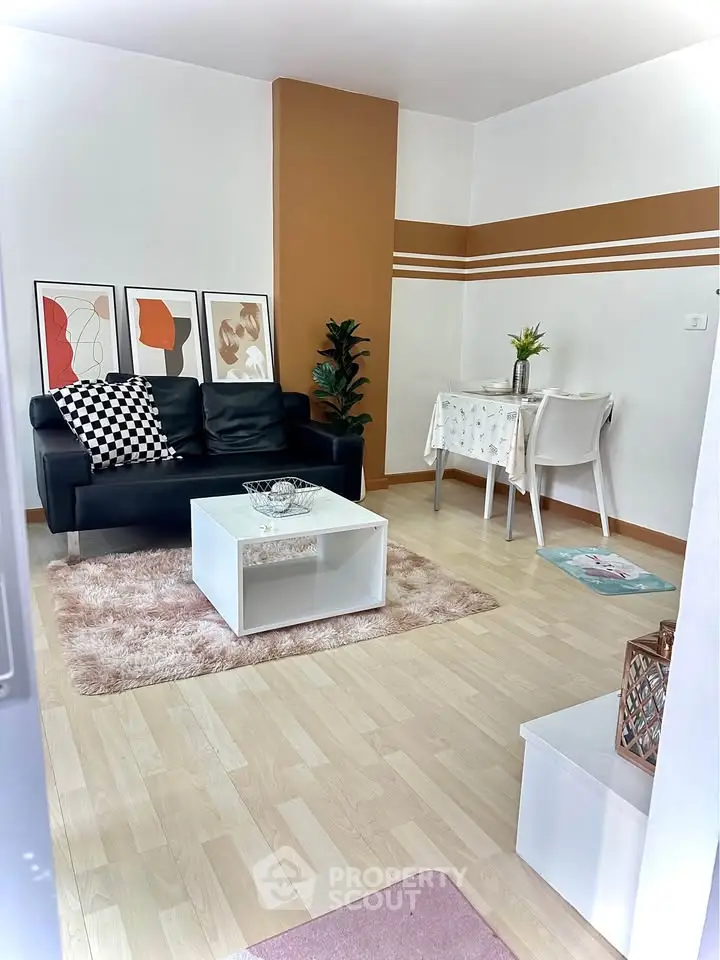 Chic living room with modern decor, stylish sofa, and cozy dining area in a contemporary apartment.