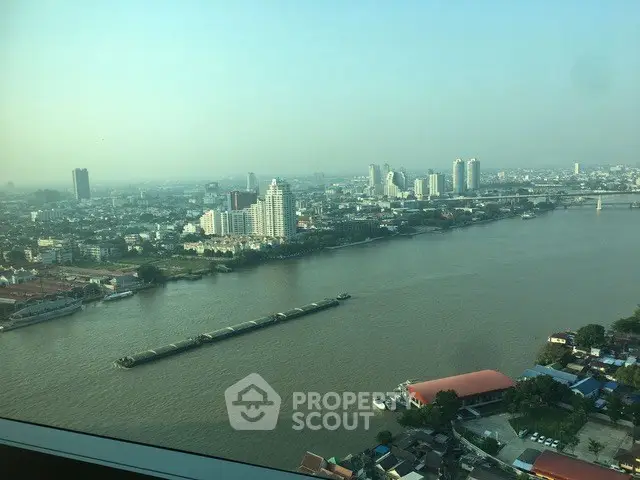Stunning river view from high-rise apartment showcasing city skyline and serene waters.
