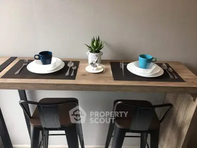 Modern kitchen dining area with stylish bar stools and minimalist decor