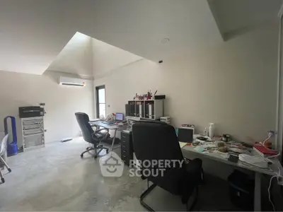 Spacious home office with modern furniture and natural light