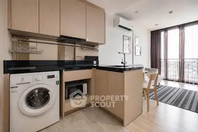 Modern open-layout kitchen with washing machine and stylish living area
