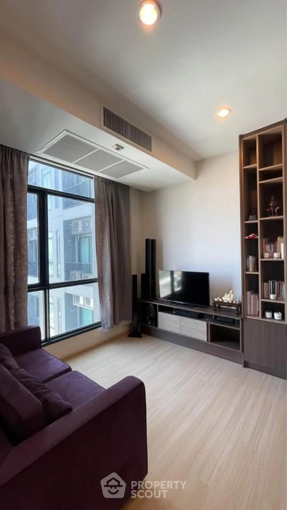 Modern living room with large window and built-in entertainment unit