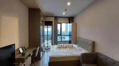 Modern bedroom with city view, featuring a cozy bed, stylish decor, and ample natural light.