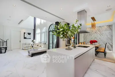 Luxurious open-plan living and dining area with modern kitchen and elegant decor.
